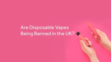 Person holding an SKE Crystal Bar vape against a vivid pink background