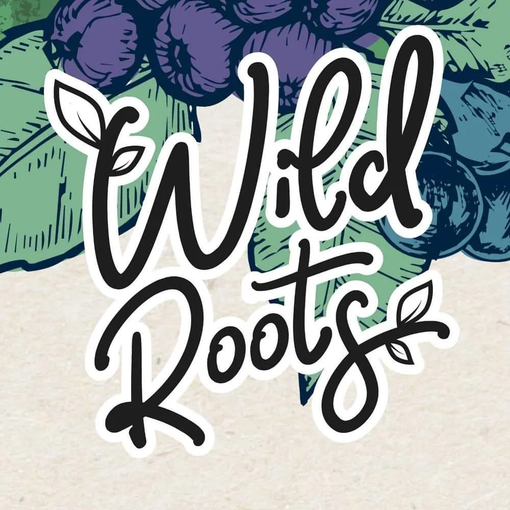 Wild Roots brand logo with botanical grape and berry illustrations in green, purple and teal, capturing the natural, eco-conscious identity of the brand