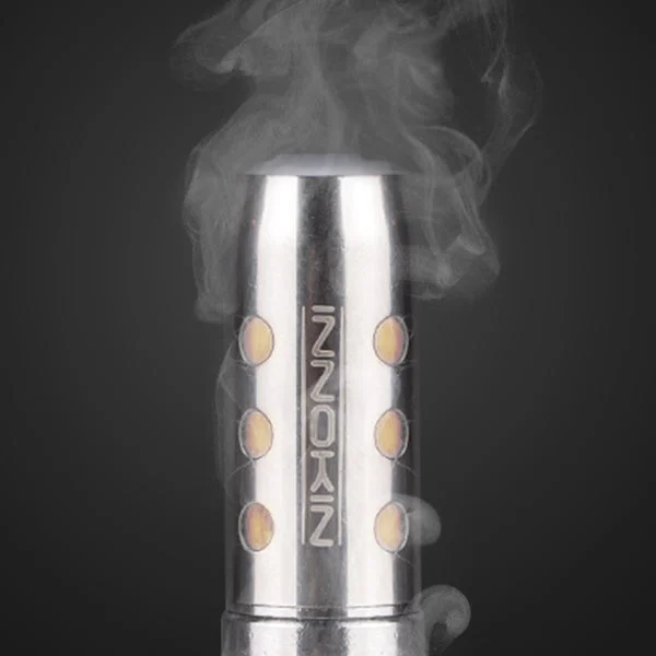 A used vape coil beside a replacement, showing the contrast between new and depleted cotton
