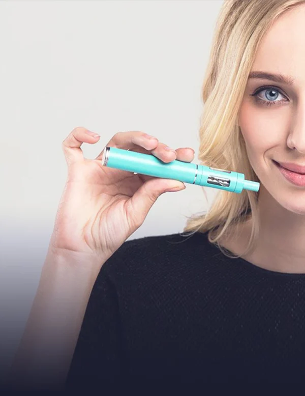 Woman holding an Innokin Endura T18E vape pen in aquamarine, showing the compact pen-style form factor