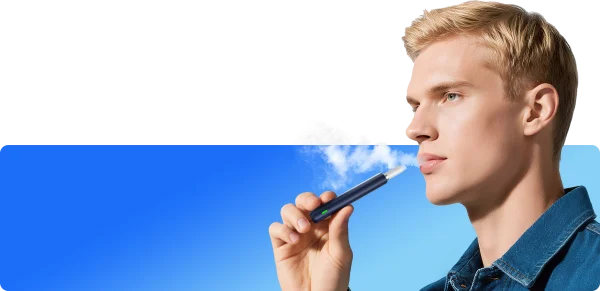 Man drawing on the OXVA SlimStick device against a blue sky background showing the slim cigarette-profile in use
