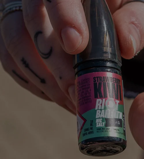 Riot Bar EDTN Strawberry Kiwi 10ml nicotine salt bottle held in hand, showing the 50PG 50VG nic salt format